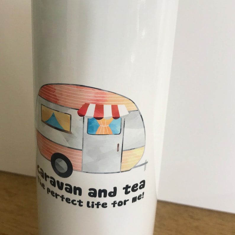May include: White travel mug with a watercolor illustration of a caravan and the text "caravan and tea the perfect life for me!"