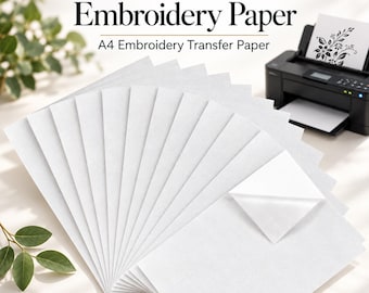 May include: A stack of white A4 water soluble embroidery paper sheets arranged in a fan shape. One sheet has a corner peeled back to reveal the adhesive side. The text Water Soluble Embroidery Paper A4 Embroidery Transfer Paper is visible.