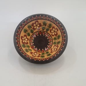 May include: A set of three ceramic mugs with a speckled, matte finish. The mugs are in shades of cream, light gray, and dark gray. Each mug has a simple, minimalist design and a rounded handle.