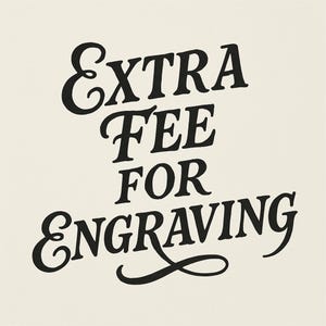 May include: Black and white text on a cream background that reads "Extra Fee for Engraving".