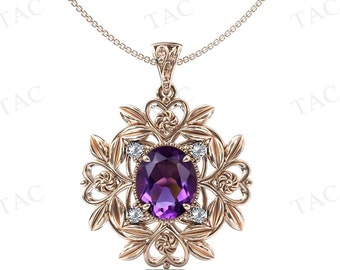 May include: A gold pendant necklace with a large purple gemstone surrounded by smaller clear gemstones. The pendant is in a floral design.