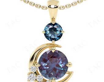 May include: A gold necklace with a crescent moon pendant featuring a large, round, iridescent gemstone surrounded by smaller, clear gemstones. A smaller, round, blue gemstone hangs above the crescent moon.