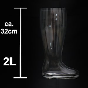 May include: A clear glass boot-shaped beer stein with a capacity of 2 liters. The stein is approximately 32 inches tall.