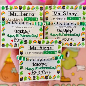 May include: Three St. Patrick's Day teacher gifts. Each card has a bracelet with white letter beads spelling "LUCKY". The cards say "Our class is incredibly lucky to have you as our teacher! Happy St. Patrick's Day!"