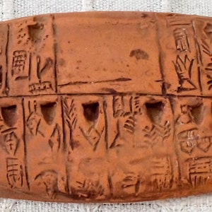 Clay tablet inscribed with an Archaic Pictographic script. Originating in Mesopotamia in the late fourth.