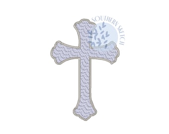 May include: A light blue cross with a decorative design. The cross is outlined in a darker blue. The cross is a religious symbol.