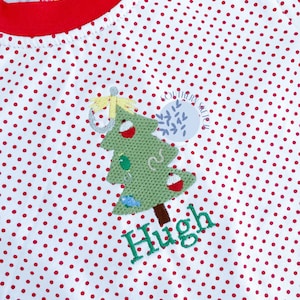 May include: White, red polka dot shirt with a red trim. The shirt features an embroidered Christmas tree design with fishing bobbers and the name "Hugh" in green. The text "Southern Salted" is also visible.