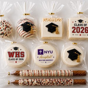 May include: A collection of graduation-themed treats in clear plastic packaging, including cake pops, rice cereal squares, and cookies decorated with black mortarboard caps, the text "CLASS OF 2026", "WHS", and "NYU Accepted!", plus two chocolate-dipped pretzel rods.