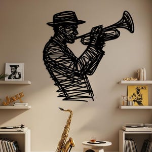 May include: A black metal wall art piece depicts a musician playing a trumpet. A golden saxophone stands on a black stand. The image has a jazz theme, with records and a small table with a drink.