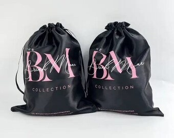 May include: Two black satin drawstring bags with pink lettering that reads "The Brush Manor Collection".