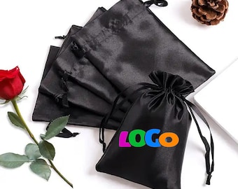 May include: A set of five black satin drawstring bags with a single bag featuring the word "LOGO" in colorful letters.