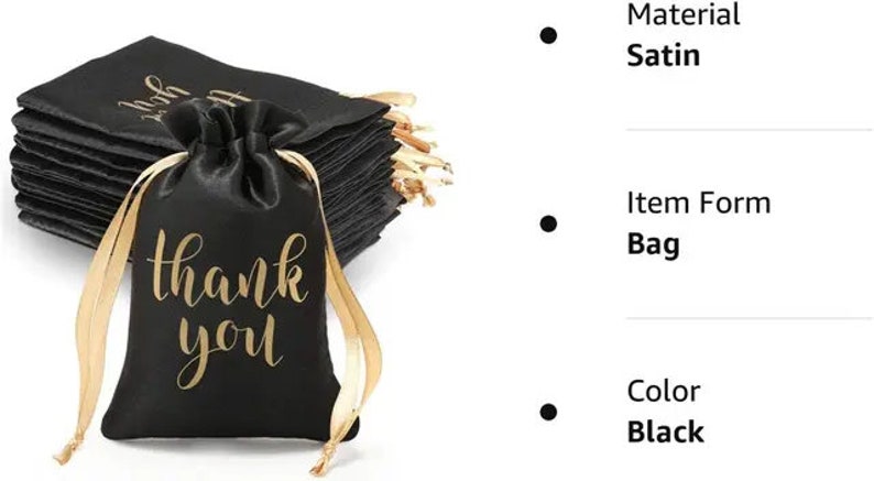 May include: Black satin drawstring bags with gold "thank you" text. The bags have gold ribbon drawstrings and are stacked in a pile. These small bags are ideal for party favors, gifts, or small retail items.