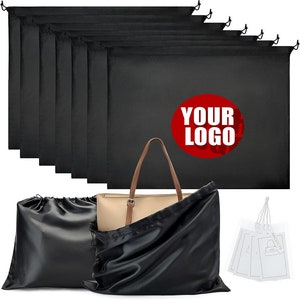 May include: Set of 10 black dust bags for handbags, with a satin dust bag and a tote bag. The dust bags have a drawstring closure and are perfect for storing and protecting your handbags. The tote bag has a brown leather handle and is made of a beige material. The dust bags have a red circle with the text "YOUR LOGO" printed on them.