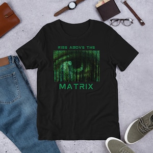 May include: Black t-shirt with a green and black graphic of a digital code pattern. The text "Rise Above The Matrix" is printed on the shirt.