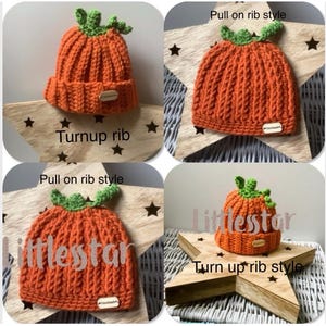 May include: A knitted orange pumpkin hat with a green stem. The hat has a ribbed design and a small tag. The text "Turnup rib" is below the hat. The hat is displayed on a wooden star.