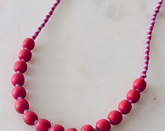 Choker-style necklace in purple and red with handmade polymer clay beads.