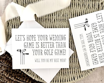 May include: White card with the text "LET'S HOPE YOUR WEDDING GAME IS BETTER THAN YOUR GOLF GAME! WILL YOU BE MY BEST MAN?" and golf club illustrations. The card is on a woven basket.