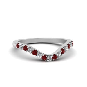 May include: A white gold contoured wedding band with a row of alternating round ruby and diamond stones.