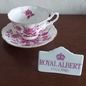 Large cup and saucer from Royal Albert Bone China England decorated with pink colored flowers with a bit of yellow and gold rimmed, 1950s