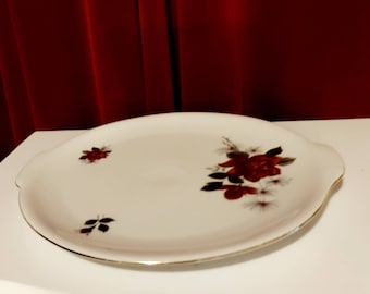 Large flat serving bowl from Scherzer Bavaria decorated with several red roses and gold rim and has 2 small handles vintage 80s