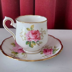 Ladies Cup and saucer from Royal Albert Bone China American Beauty. Decorated with beautiful pink roses and bordered with gold lines