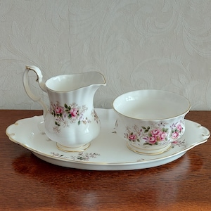 Complete cream set from Royal Albert Bone China England Lavender Rose decorated with roses and green leaves and is gold edged Vintage 80s