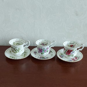 Ladies sets of cups and saucers from Royal Albert Flower of the month from January to December, decorated with flowers and gold lines.