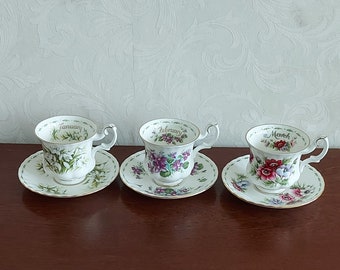 Ladies sets of cups and saucers from Royal Albert Flower of the month from January to December, decorated with flowers and gold lines.