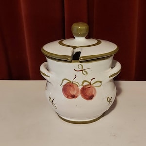 Beautiful large earthenware sugar bowl painted with red fruit and green stripes.