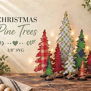 May include: A collection of flat, cutout wooden pine trees featuring various plaid patterns in red, green, and blue. The text CHRISTMAS Pine Trees 1/8" SVG is displayed on the left. Each tree stands on a small circular base with twine.