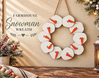 May include: A circular wreath composed of ten white wooden snowman faces, each featuring two black dot eyes and a protruding orange carrot-shaped nose. The wreath is suspended by a brown rope and includes the text FARMHOUSE Snowman WREATH.