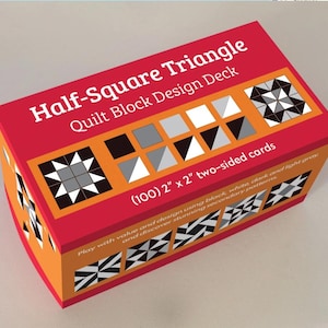 May include: A red and orange box labeled "Half-Square Triangle Quilt Block Design Deck" containing 100 two-sided cards, each 2" x 2". The box features various quilt block designs in black, white, and gray.
