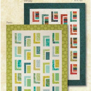 May include: A quilt pattern design by Atkinson Designs, featuring two quilt examples. The "Strippy" quilt has a dark green border, while the "Basic" quilt has a green patterned border. Both quilts have a white background with colorful geometric shapes. The text "URBAN CABIN" is visible.
