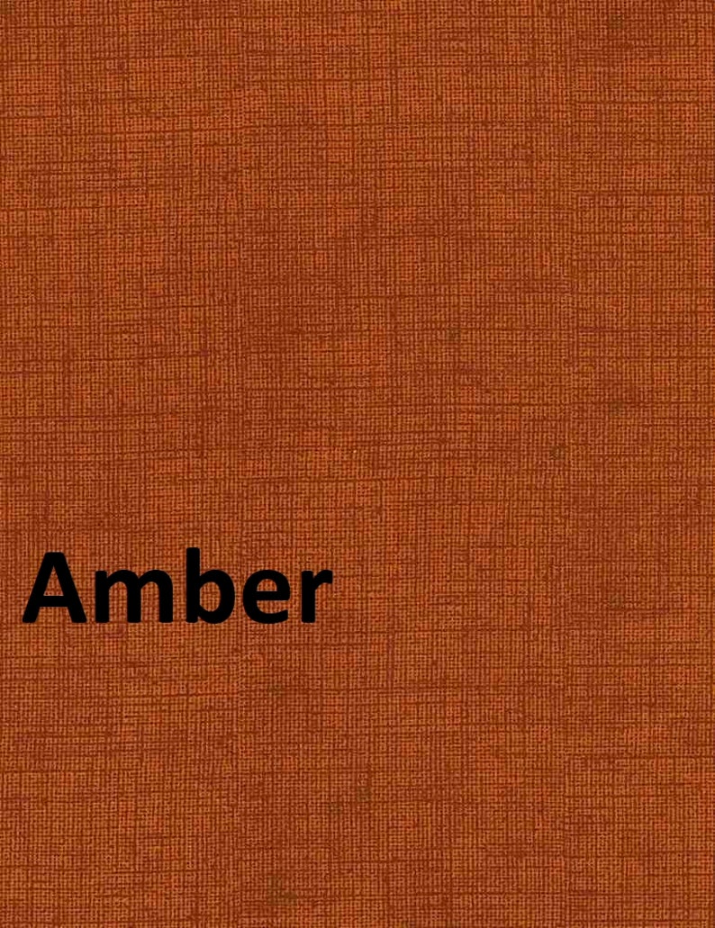 May include: A close-up of a textured fabric in a rich amber color. The word "Amber" is printed in black letters on the fabric.