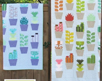 May include: Two quilt patterns featuring a greenhouse theme with patchwork plants in various colors and designs. The patterns are titled "Greenhouse" and are by Elizabeth Hartman.