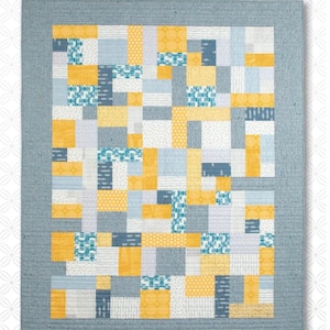 May include: A quilt pattern titled "Yellow Brick Road" by Atkinson Designs. The design features a patchwork of yellow, blue, and gray rectangular blocks. The quilt is framed by a gray border. The text "Simple Patterns-Tried and True" is also visible.