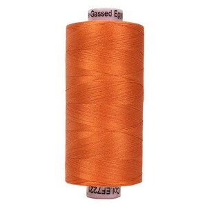May include: A spool of vibrant orange sewing thread wound tightly around a cylindrical core. The top label reads Gassed Egy and the bottom label displays the text Col.EF7221. The thread has a smooth, consistent texture and a slight sheen.