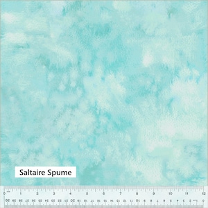 May include: A light blue fabric with a watercolor-like pattern. The fabric has a soft, faded look with shades of light blue and white. The fabric is called "Saltaire Spume".