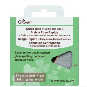May include: A green Clover package of Quick Bias fusible bias tape. The package includes text in multiple languages and states it is excellent for stained glass quilting, Celtic, and appliqué work. The tape is 1/4 in. (6 mm) wide and 11 yards (10 m) per reel.