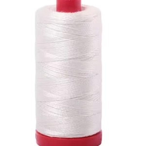 May include: A spool of white thread with a red base and top. The thread is tightly wound, creating a cylindrical shape. Ideal for sewing, embroidery, or other crafting projects.