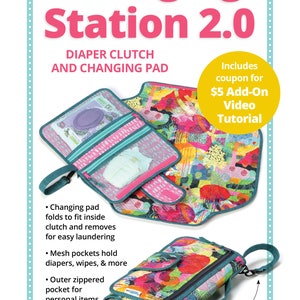 May include: A turquoise and pink changing station with a zippered pocket and mesh pockets. The changing pad folds into the clutch for easy storage. The clutch has a carrying handle and a wrist/stroller strap. The text "Changing Station 2.0" is printed in pink on a turquoise background. The text "Diaper Clutch and Changing Pad" is printed in black on a white background. The text "Includes coupon for $5 Add-On Video Tutorial" is printed in yellow on a white background.