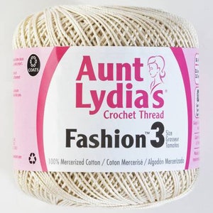 May include: A ball of Aunt Lydia's Fashion 3 crochet thread in a cream color. The label reads "Aunt Lydia's Crochet Thread" and "Fashion 3" with the text "100% Mercerized Cotton/Coton Mercerisé/Algodón Mercerizado" at the bottom.