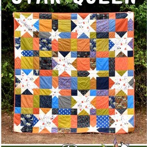 May include: A colorful quilt with the text "STAR QUEEN" at the top. The quilt features a patchwork design with star patterns and squares in orange, blue, green, and white. The bottom of the image has the text "Running Doe Quilts".