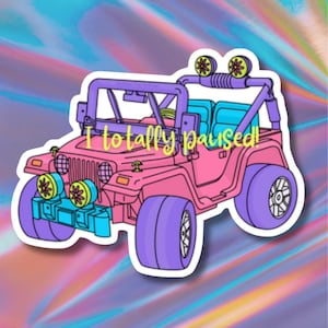 May include: A pink cartoon jeep sticker with purple accents, blue seats, and yellow headlights. The text "I totally paused!" is written across the front of the jeep. The background is a colorful, holographic design.