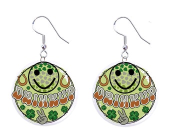 May include: A pair of green and gold earrings with a smiley face, shamrocks, and the text "Drink Up" in a retro font.