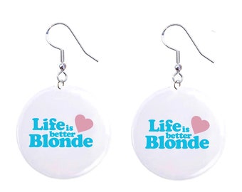 May include: A pair of white button earrings with a silver hook. The buttons have the text "Life is better Blonde" in blue with a pink heart.