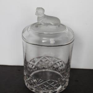 May include: A white ceramic mug with a black handle and the text "But First, Coffee" in a handwritten style. The mug is on a white surface. The mug is 4 inches tall.