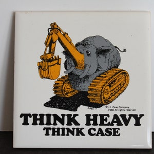 May include: Square white tile with a cartoon illustration of an elephant with an excavator arm and treads. The elephant is gray and the excavator is orange. Text at the bottom reads "THINK HEAVY THINK CASE."