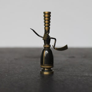 May include: A set of three ceramic mugs with a speckled, cream-colored glaze. Each mug features a different hand-painted floral design in shades of blue, green, and yellow. The mugs have a simple, rounded shape and a comfortable handle.