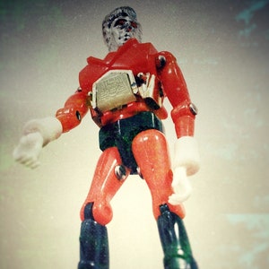 Photograph of a Long Legged Vintage Plastic Toy Robot